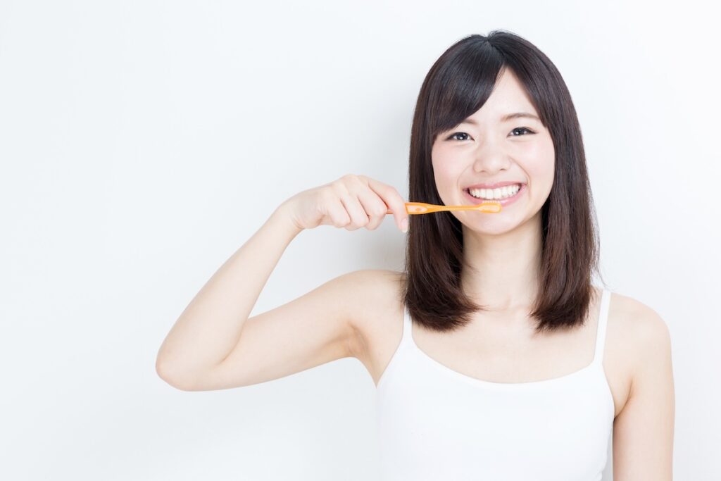 銀歯の下が虫歯になるのを防ぐために歯磨きをする人